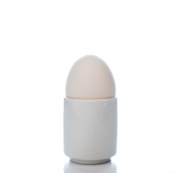 White chicken egg in a stand isolated