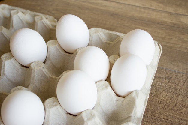 White chicken eggs in a cardboard tray