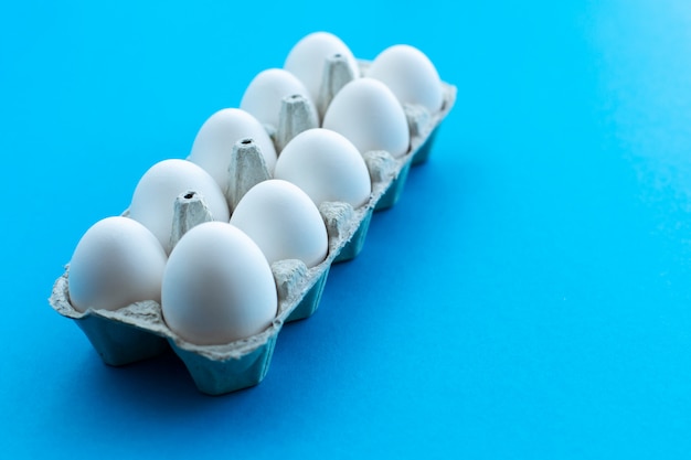 White chicken eggs in an open cardboard box 