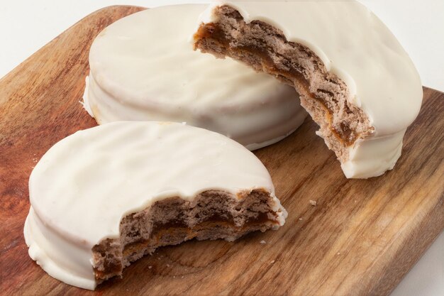 White chocolate alfajor on cutting board