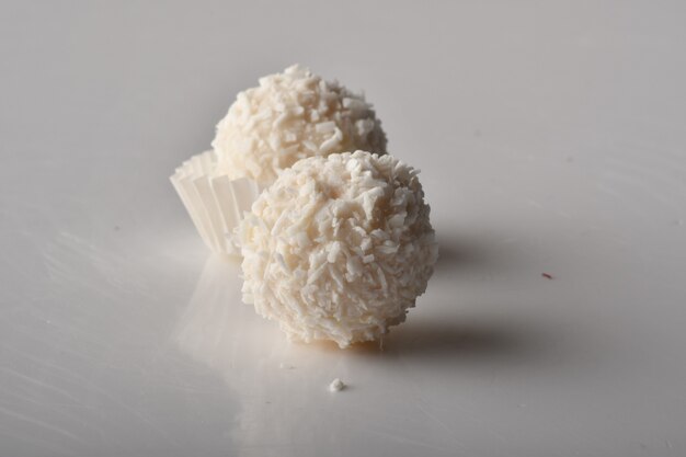 White Chocolate Candy With Coconut Topping On White Background