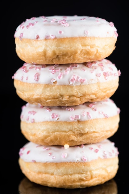 White Chocolate Donuts or Doughnuts Tower on Dark Background