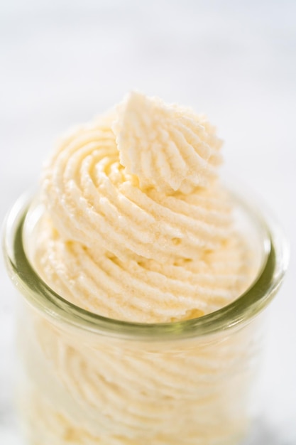 White chocolate ganache frosting in a small glass mason jar