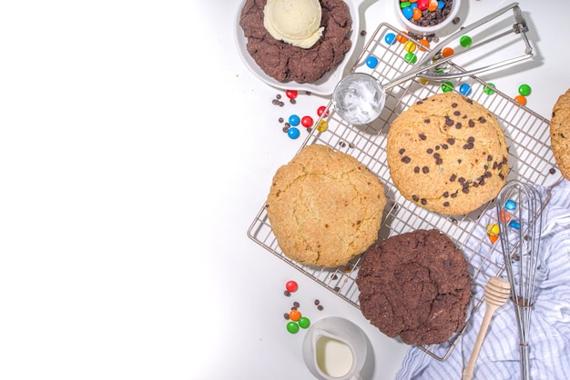 White and chocolate giant cookies. Very big cookies Ã¢ÂÂ chocolate, vanilla, chocolate chips, with ice cream ball. Trendy sweet baking.