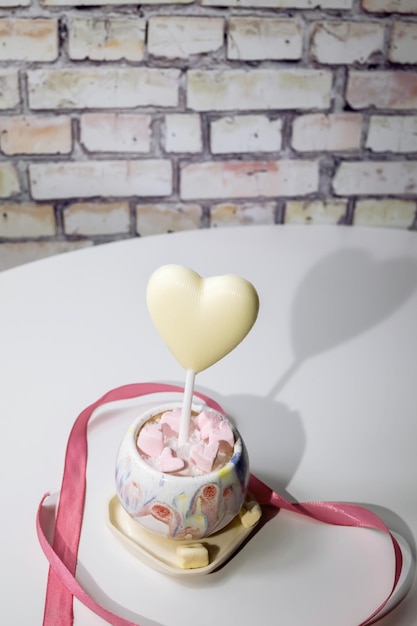 White chocolate heart in a pot. Valentine's day background