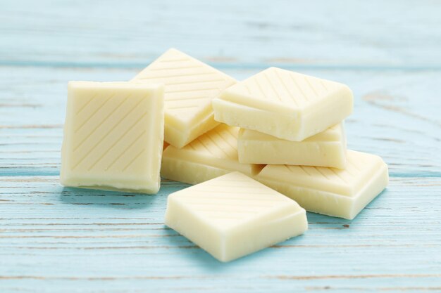 White chocolate pieces on wooden table