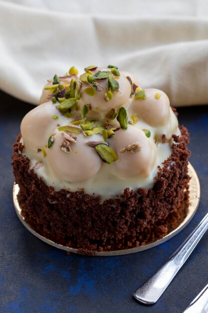 White chocolate profiterole cake on a black and blue background