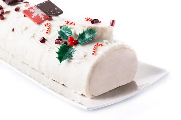 white chocolate yule log cake with ornament