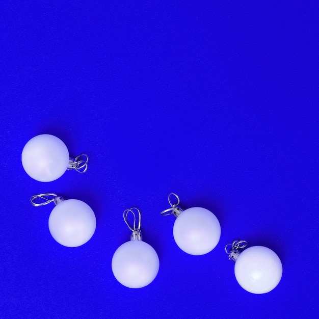 White Christmas balls ornaments isolated on blue