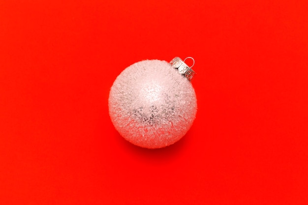 White christmas balls on a red background with space for text