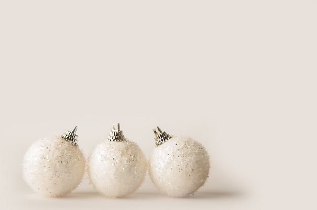 White Christmas balls on a white background close-up and copy space.