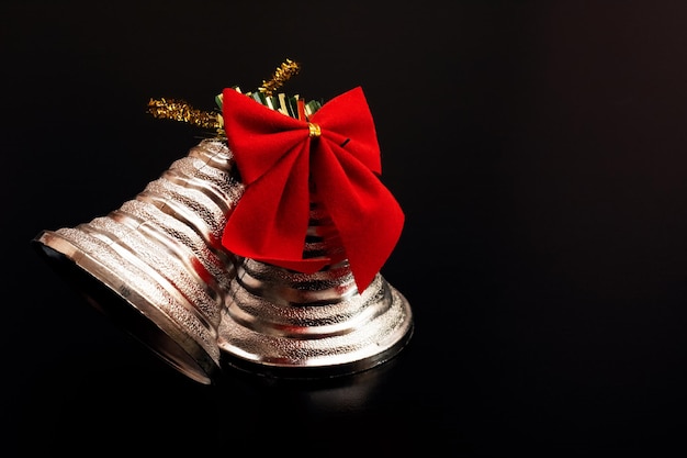 White Christmas bells with a red bow copy space