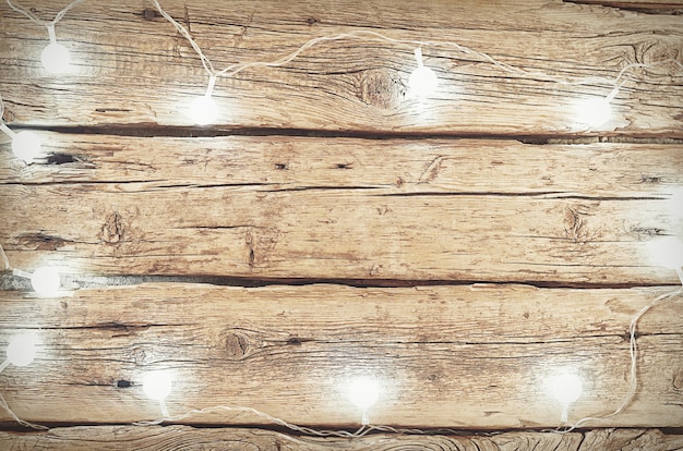 White christmas lights on a wooden background