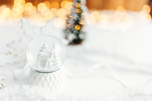 White christmas snow globe on a table with christmas decorations. High quality photo