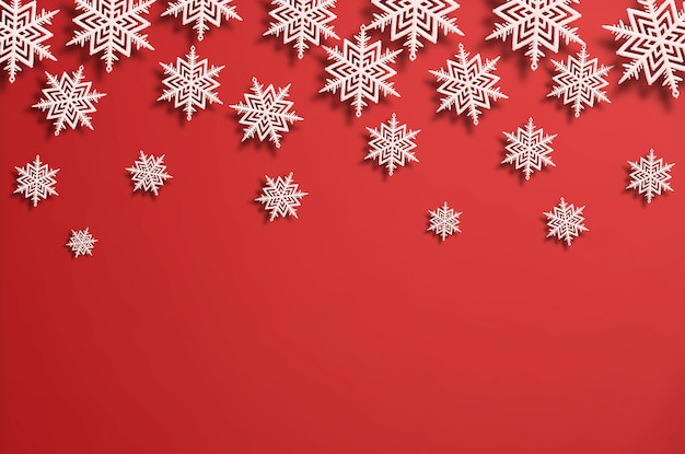 White christmas snowflakes of various sizes on red, flat lay