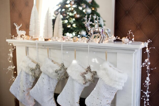 White Christmas socks hanging on fireplace