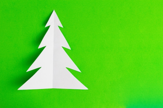 White christmas tree on green background