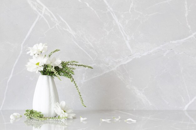 White chrysanthemums in  vase a on gray marble background