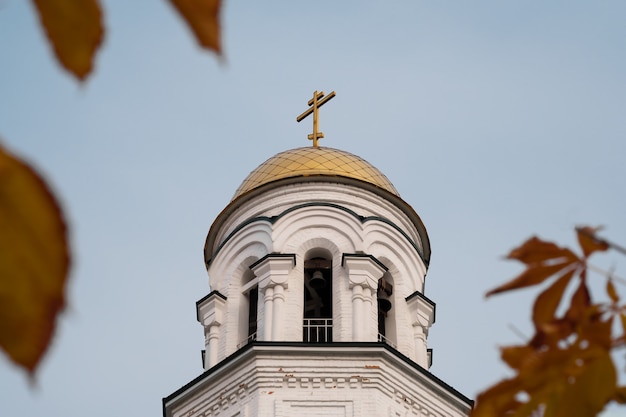 White church with autumn leaves in defocus