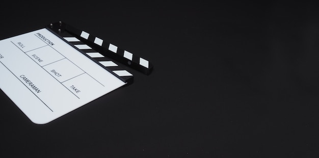 White Clapperboard or clap board or movie slate use in video production ,film, cinema industry on black background.