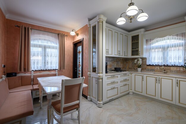 White classic cozy kitchen and dining room in city house