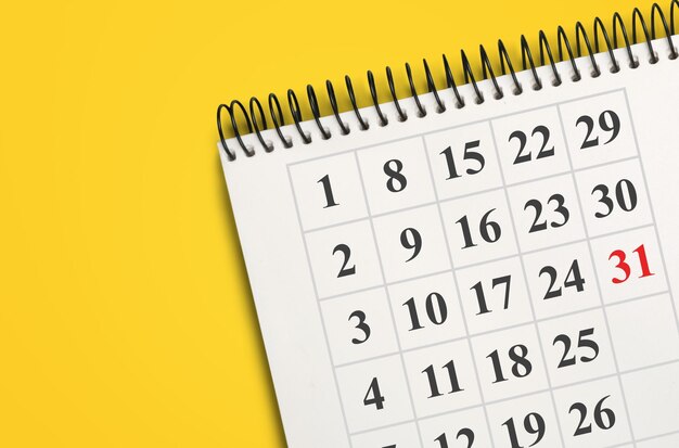 White clean calendar on solid yellow background with copy space, business meeting schedule,