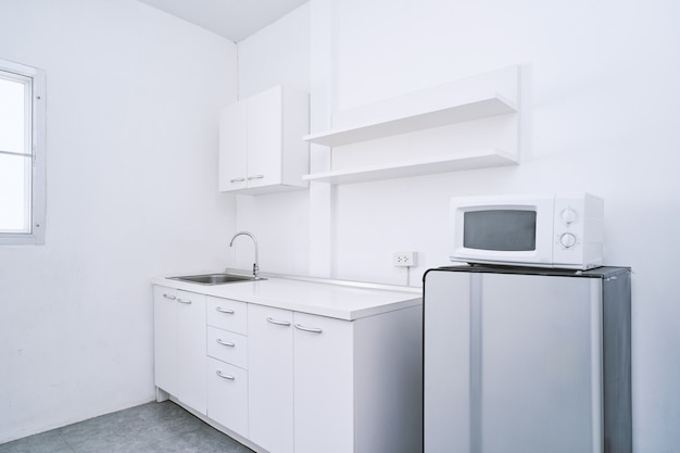 White clean kitchen room with built-in furniture decoration