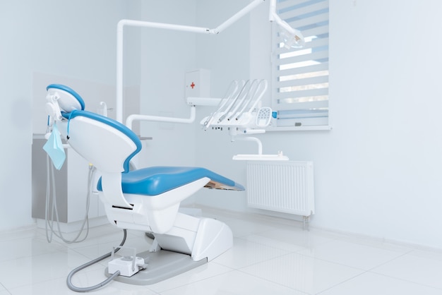 White clean nice chair and set of equipment standing in the middle of a well lighted room and waiting for a new day to start