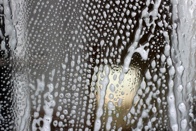 White cleaning foam on glass