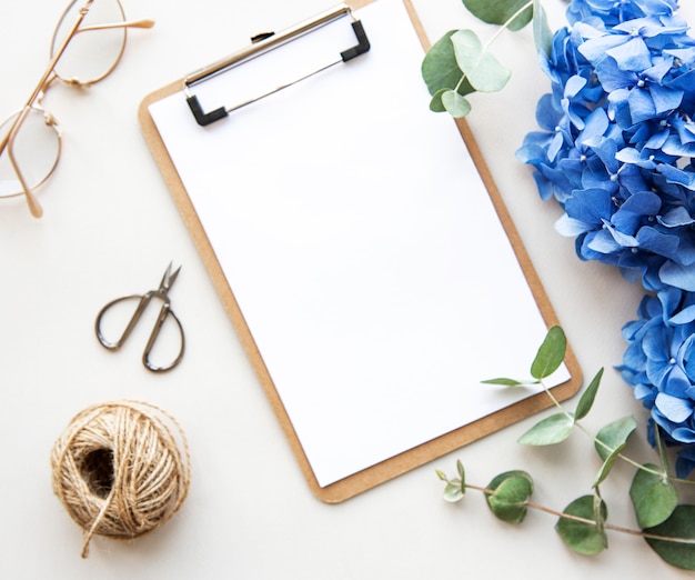 white clipboard with blue flowers