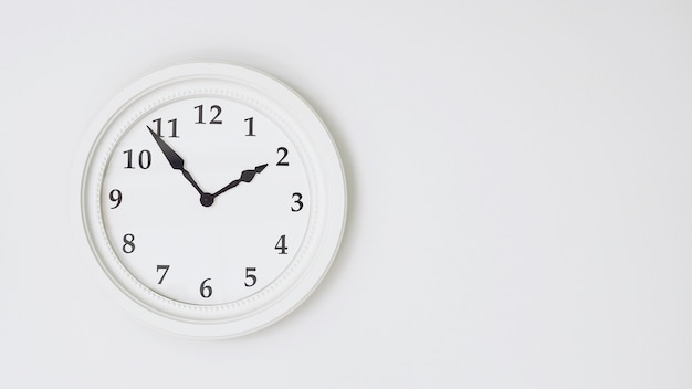 White clock on white background.