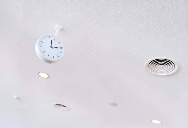 White clock on white futuristic background