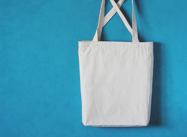 White cloth bag with straps hangs