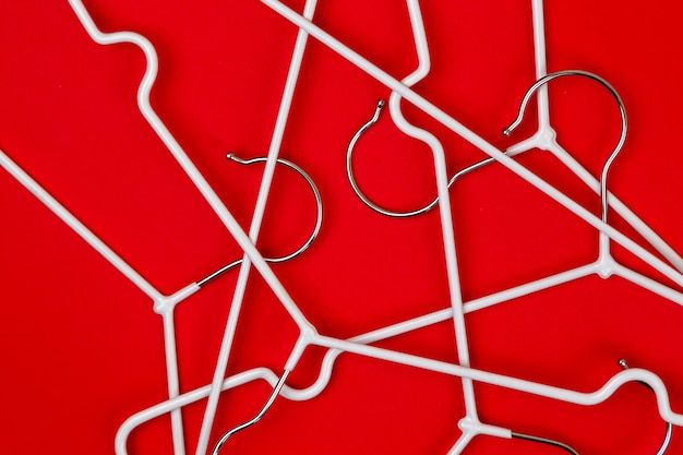 White clothes hangers on red