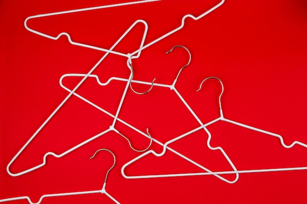 White clothes hangers on red