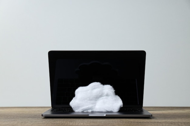 A white cloud made of cotton wool on a laptop keyboard