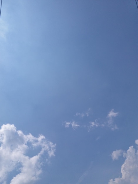 White clouds almost cover the blue sky or a clear blue sky filled with white clouds during the day