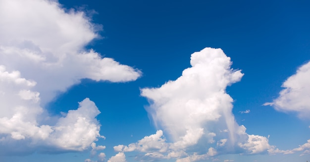 White clouds on blue sky background.