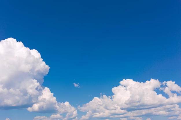 White clouds on blue sky background.