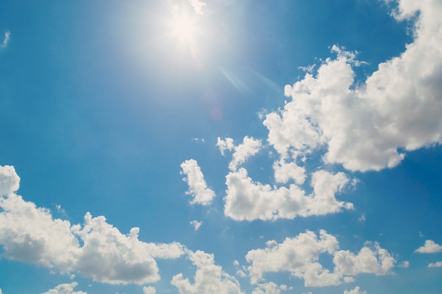 white clouds in the blue sky and sun