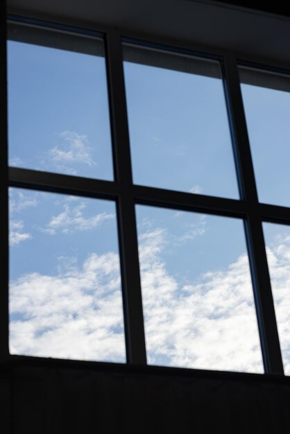 White clouds in the blue sky taken through the window