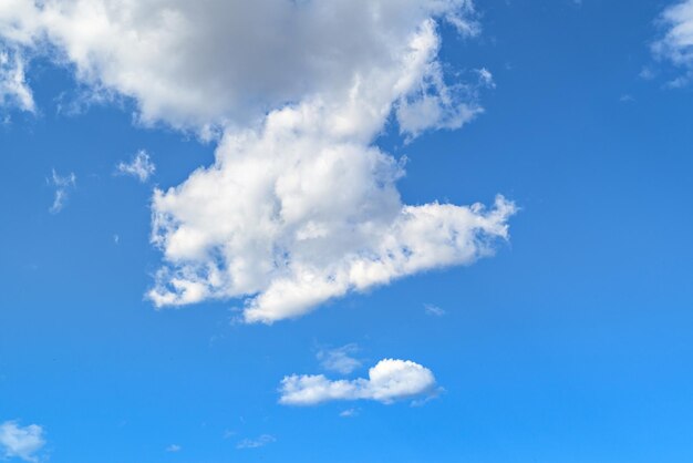 White clouds in a bright blue sky. The beauty of the nature.