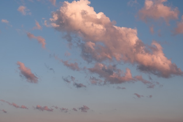 White clouds in summer blue sky at golden hour