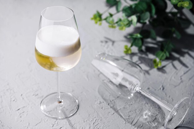 white cocktail with foam in a wine glass