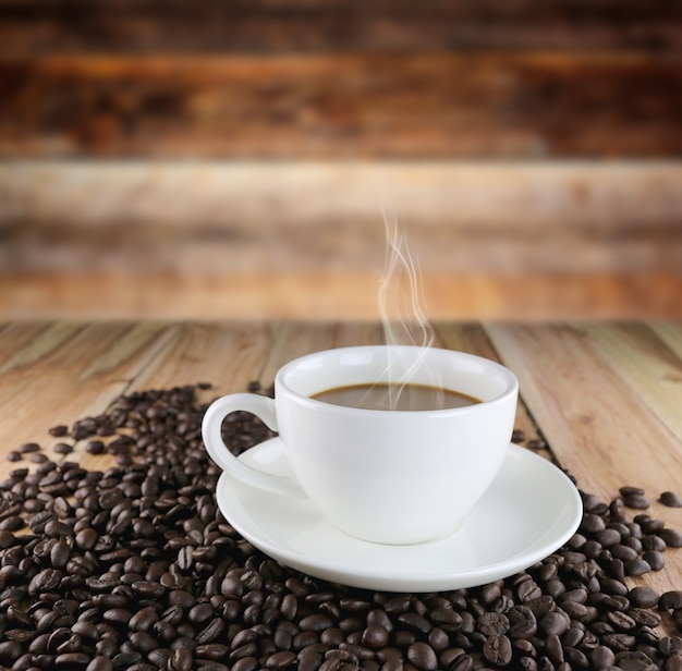white coffee cup and roasted coffee beans.