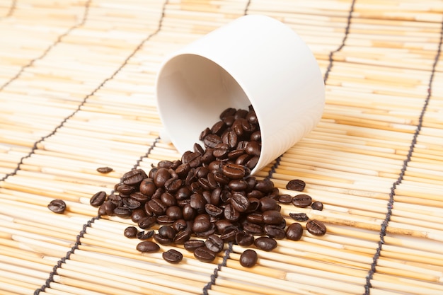 White coffee cup with coffee beans.