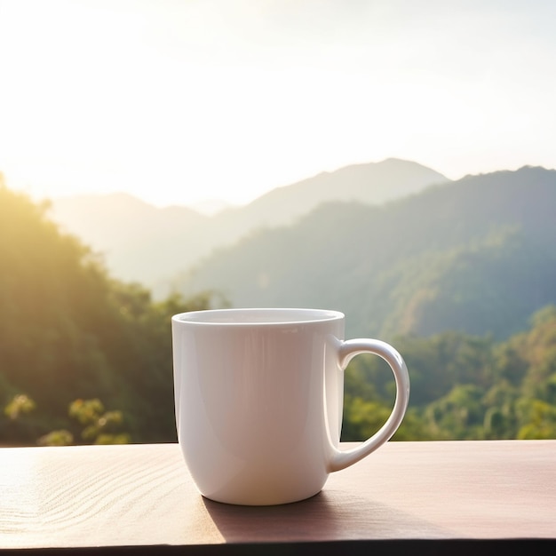 A white coffee mug sits on a table in front of a mountain range.