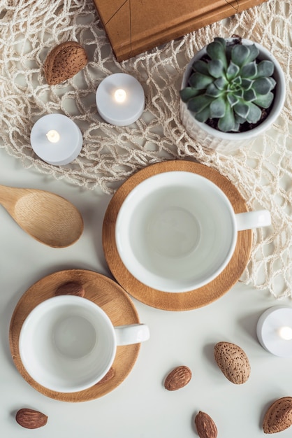 White coffee tea cups and almond nuts composition