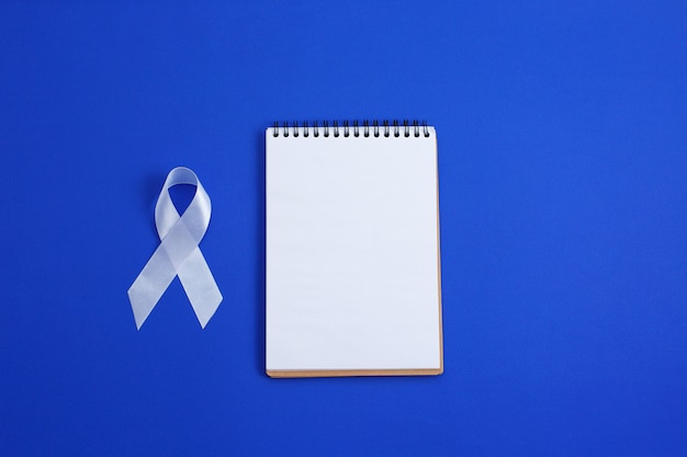 Photo white color ribbon for raising awareness on lung cancer and multiple sclerosis and international day of non-violence against women.