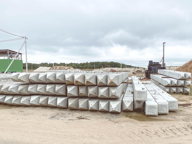 White concrete structures lie on wet ground building material for the construction of the foundation